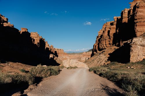 Free Charyn Canyon's majestic rock formations under a clear blue sky in Kazakhstan. Stock Photo