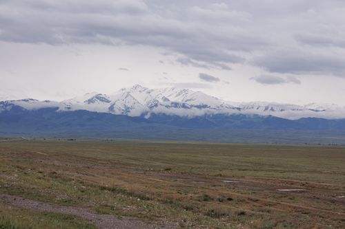 Free Beautiful snow-capped mountains under a cloudy sky in Almaty, Kazakhstan. Stock Photo