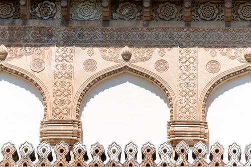 Free Close-up of ornate decorative stone carvings on a historical building facade, showcasing architectural artistry. Stock Photo