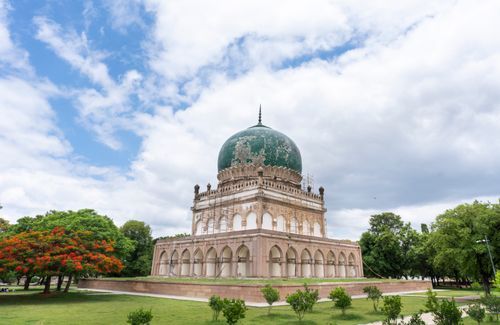 Free Stunning capture of the Qutb Shahi Tomb amidst lush greenery under a vibrant sky. Stock Photo