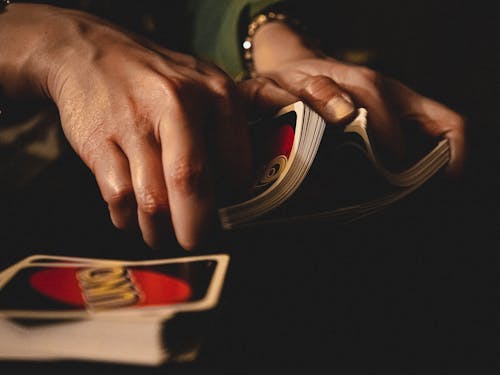 Person Shuffling Uno Cards