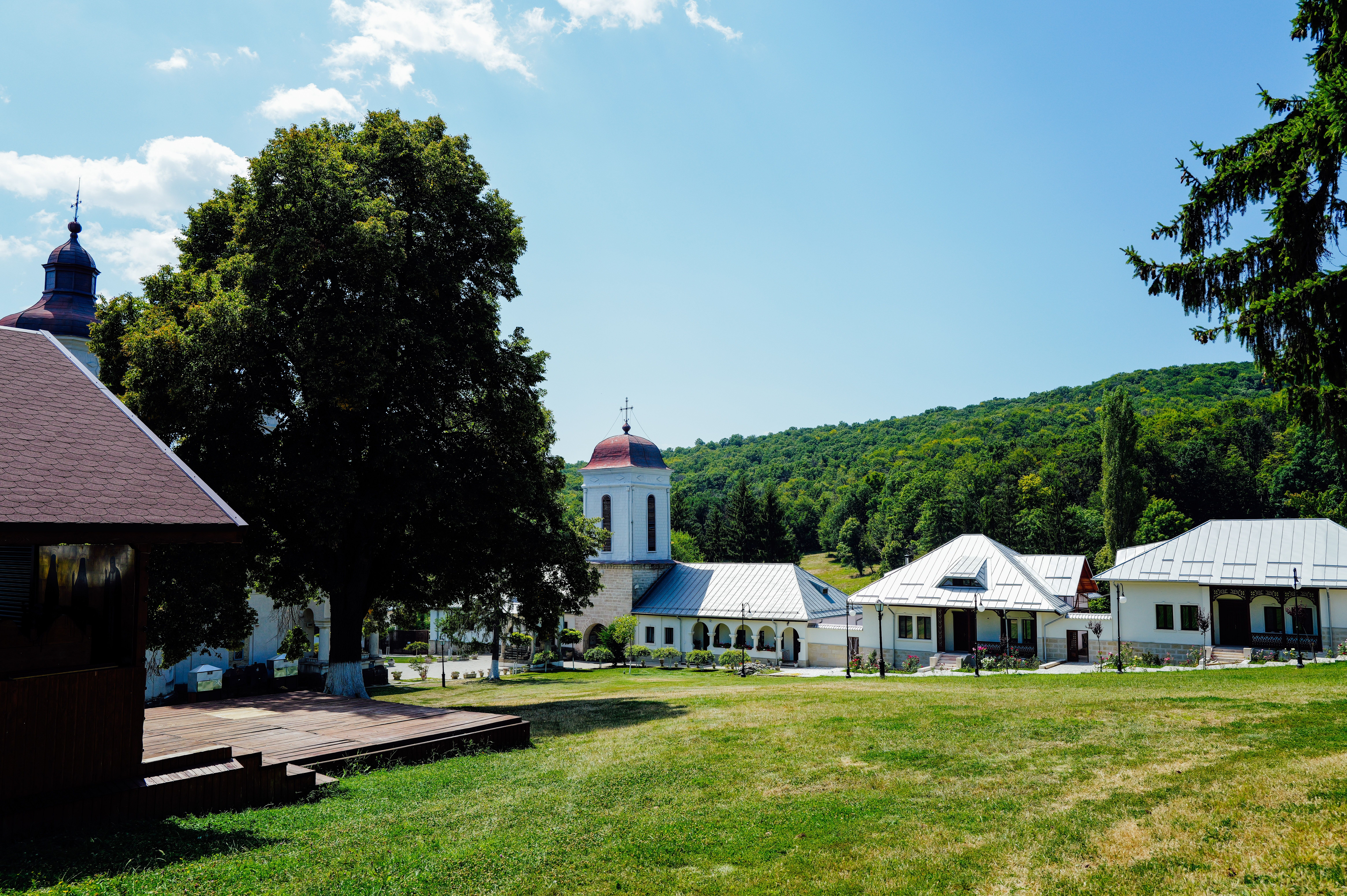 Picturesque church and village buildings with lush summer landscape.