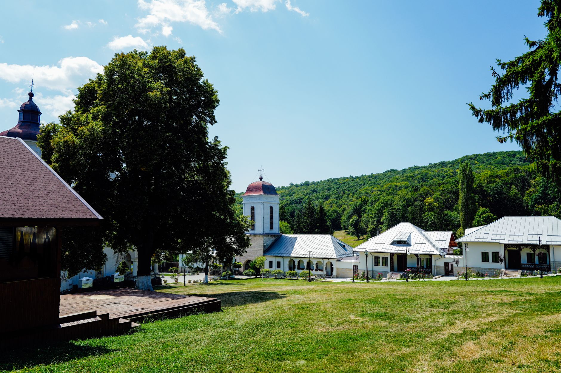 Picturesque church and village buildings with lush summer landscape.
