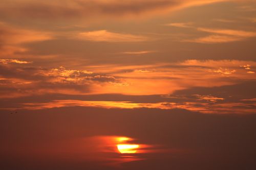 Free Eye-catching orange sunset with dramatic cloud formation. Stock Photo