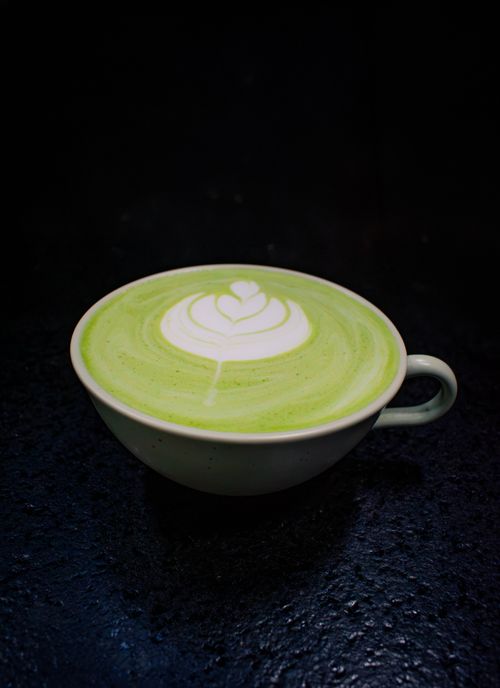 Free Detailed top view of a matcha latte with beautiful latte art on a dark background. Stock Photo