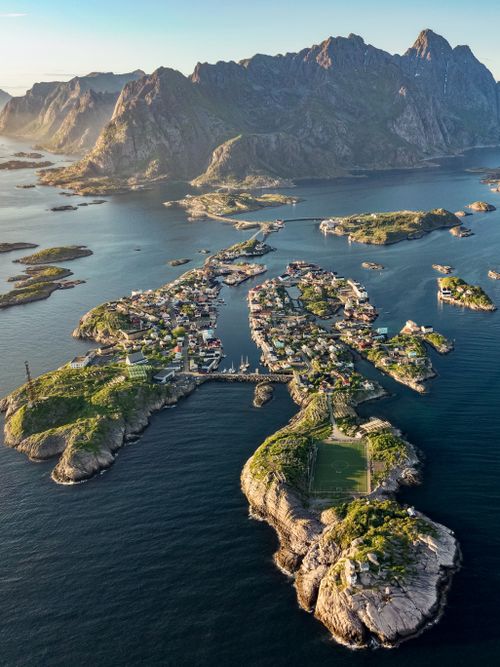 Free Stunning aerial view of Henningsvær village and surrounding landscape in Norway's Lofoten Islands. Stock Photo