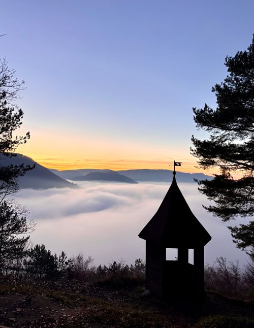 Free A picturesque sunset view over a mist-filled valley in the Black Forest, Germany. Perfect for nature lovers. Stock Photo