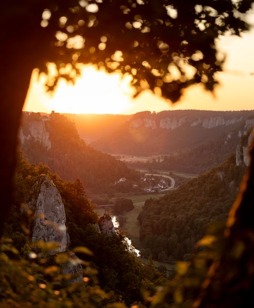Free Stunning sunset view over the Irndorf valley with rocky cliffs and verdant forest in Baden-Württemberg, Germany. Stock Photo