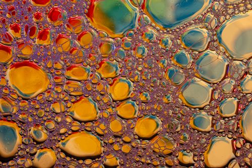 Free Colorful macro shot of vibrant soap bubbles creating an abstract texture. Stock Photo