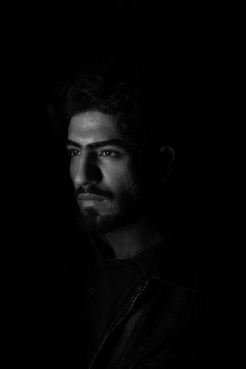 Free A striking black and white portrait of a man in dramatic lighting. Stock Photo