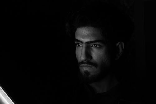 Free Moody black and white portrait capturing intense expression on a man's face. Stock Photo