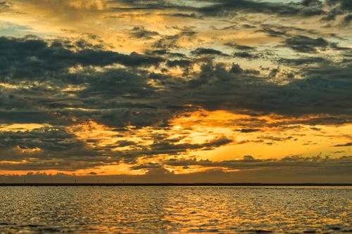 Free Capture of a breathtaking sunset with dramatic clouds over the North Sea at Borkum, Germany. Stock Photo