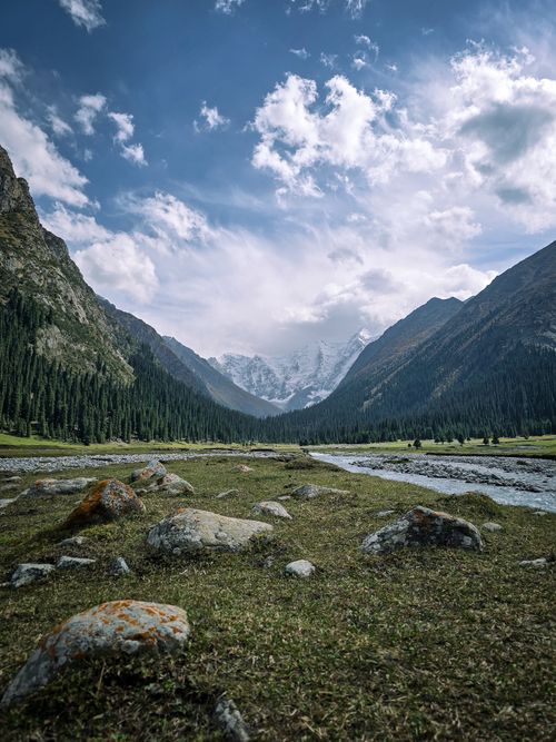 Free Dramatic mountain landscape with rocky foreground and cloudy sky in Kyrgyzstan. Stock Photo