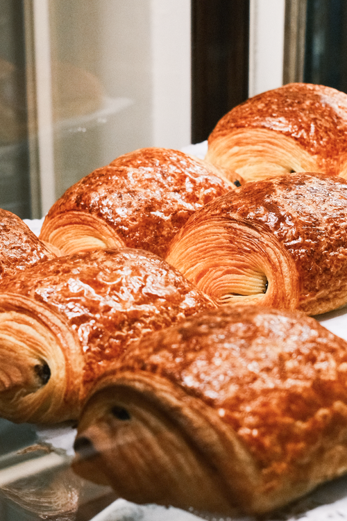 Free Deliciously golden chocolate croissants displayed in a Viennese bakery. Perfect breakfast treat. Stock Photo
