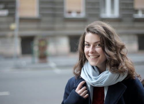 Woman in Blue Jacket and Scarf Smiling