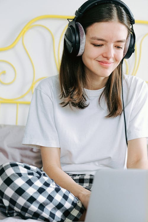 Woman In White Crew Neck T-shirt Wearing Headphones