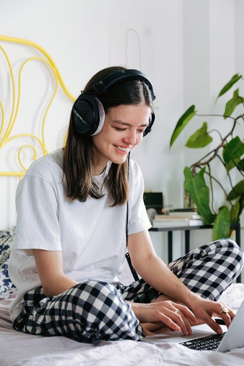 Woman In White Crew Neck T-shirt Wearing Black Headphones