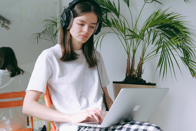 Woman In White Crew Neck T-shirt Using Laptop Computer