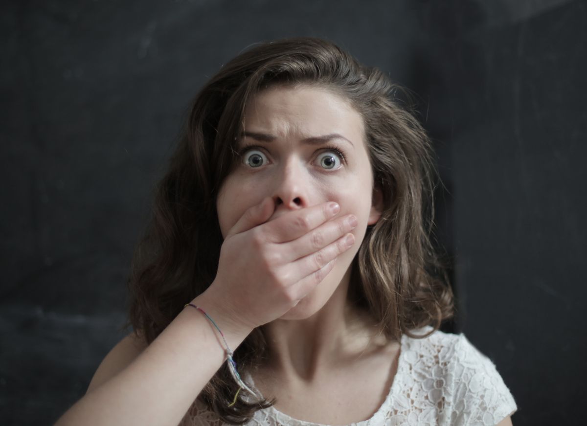 Why You Can't Smell Your Own Breath (And How to Finally Know for Sure) 1 Person covering their mouth with their hand, worried about how to tell if you have bad breath