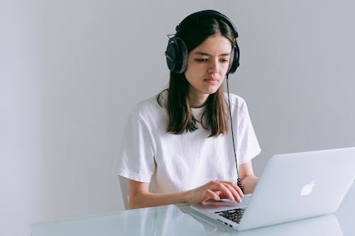 Woman In White T-shirt Using Macbook