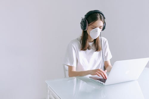 Free Woman In White Shirt Using Laptop Computer Stock Photo