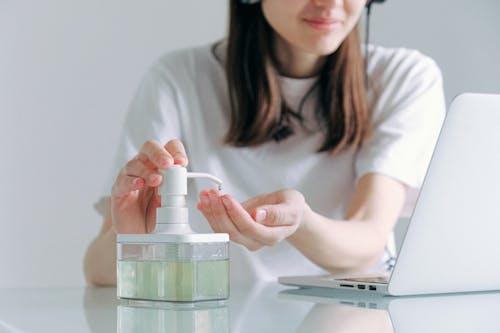 Free Woman In White Shirt Holding Clear Glass Container Stock Photo