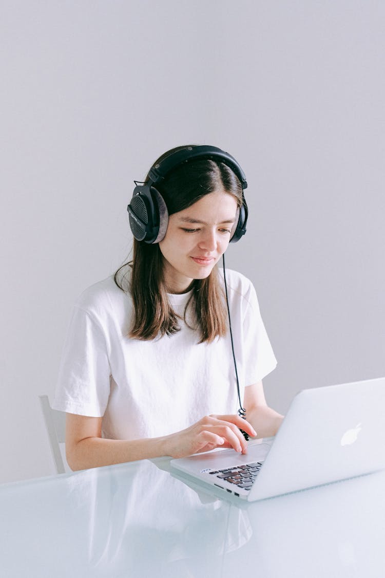 Woman In White T-shirt Using Silver Laptop Computer