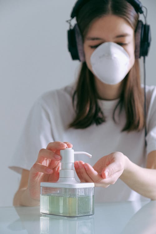 Woman In White Shirt Pumping Sanitizer