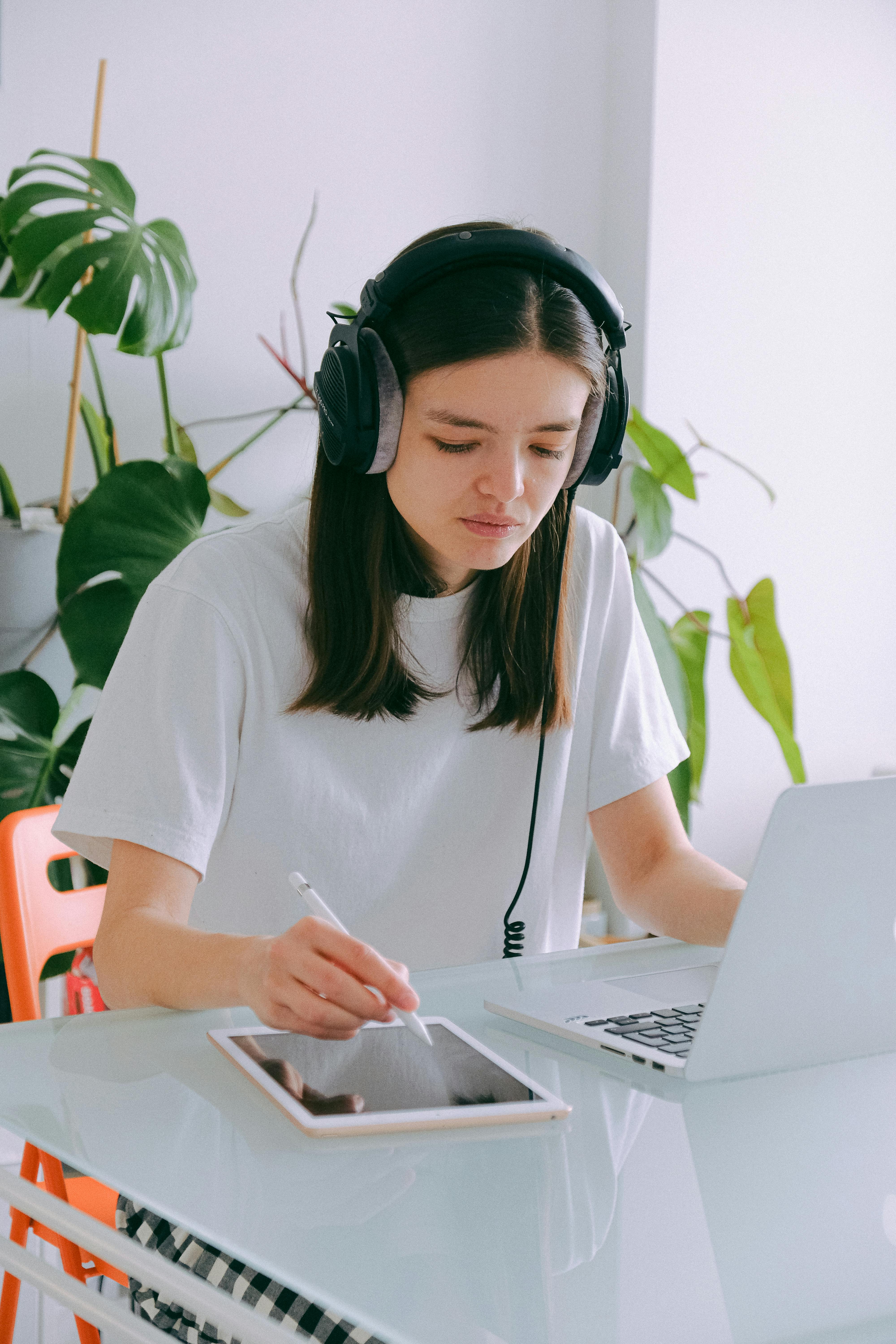 woman in white crew neck t shirt using silver macbook