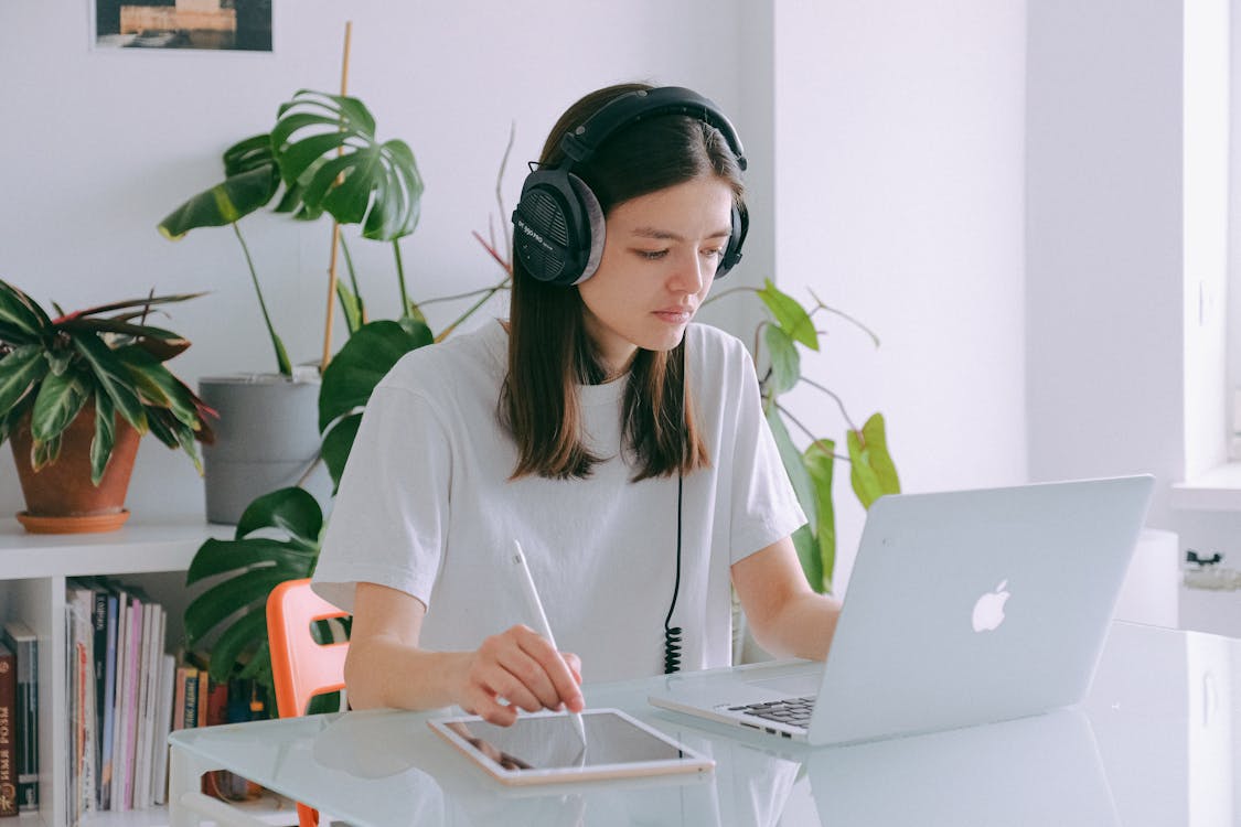 Free Woman In White Shirt Using Silver Macbook Stock Photo