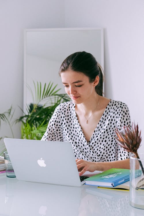 Woman In Black And White V Neck Clothing Using Macbook