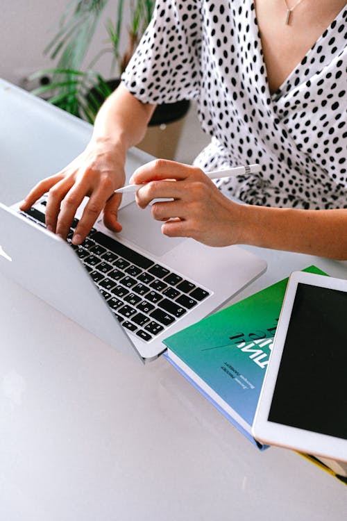 Free Person Using Macbook On Table Stock Photo