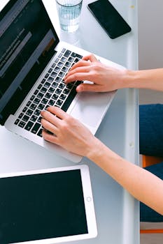 An organized home office featuring a laptop and tablet for remote work.