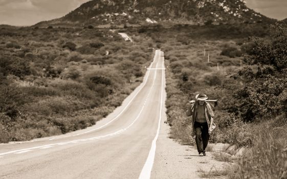 Grayscale Photo of Man Walking on Road