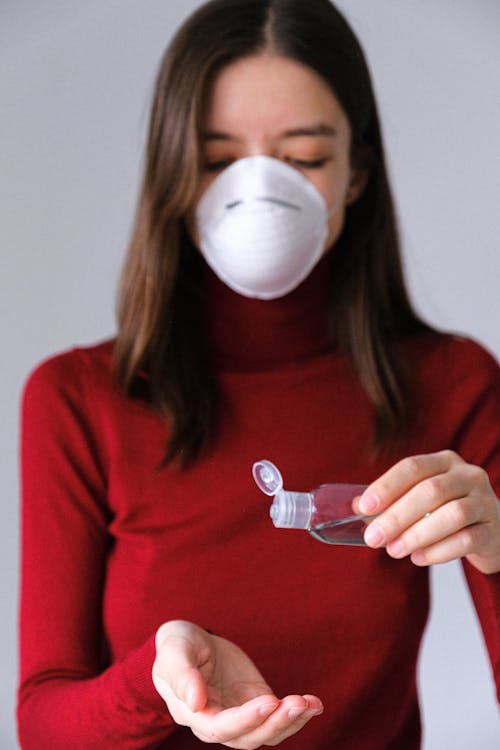 Woman Applying Hand Sanitizer