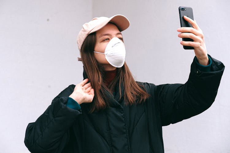 Woman In Face Mask Taking Selfie