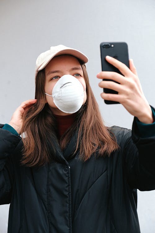 Woman in Face Mask Taking Selfie