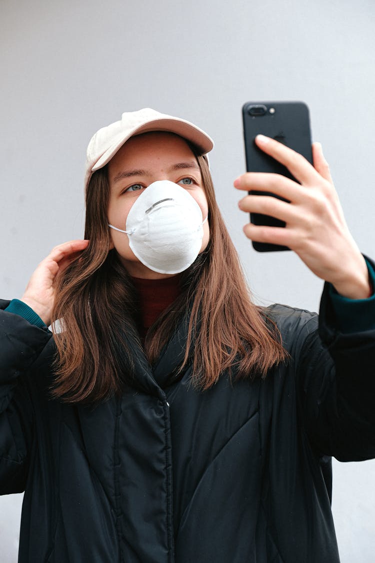 Woman In Face Mask Taking Selfie