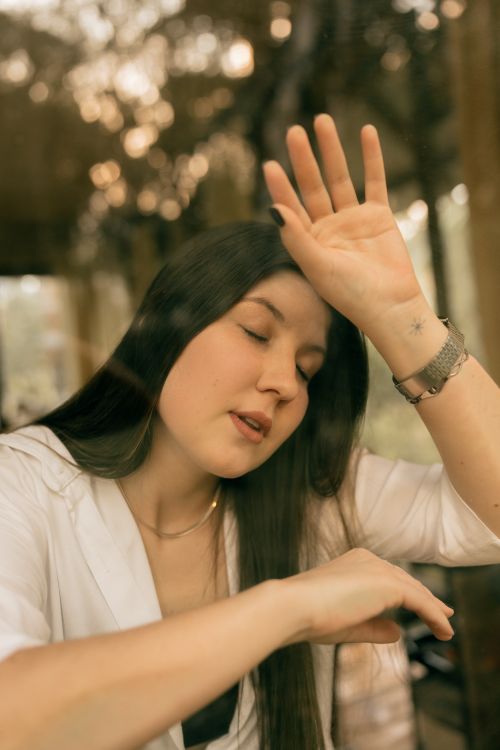 Free A serene moment of a young woman with long hair and closed eyes, conveying relaxation and calmness. Stock Photo