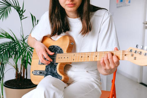 Free Woman In White Shirt Playing Brown Electric Guitar Stock Photo