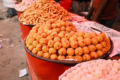 Free A variety of fried Indian snacks on a street vendor's display, vibrant and appetizing. Stock Photo