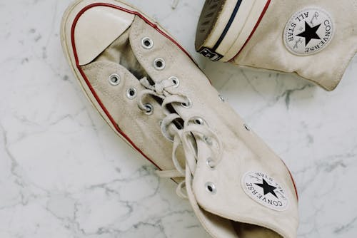 Photo Of Person Wearing Yellow Converse Shoes · Free Stock Photo