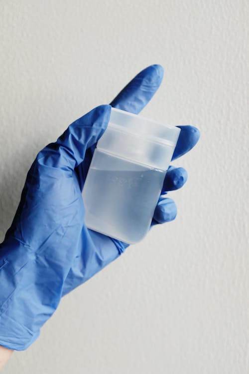 Free Person Holding Container with Clear Liquid Stock Photo