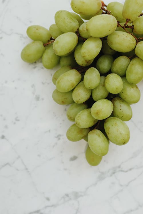 Free Green Round Fruits on White Surface Stock Photo