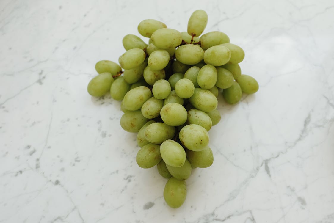 Free Green Round Fruits on White Surface Stock Photo