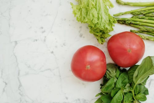 Free Red Tomato Beside Green Vegetables Stock Photo