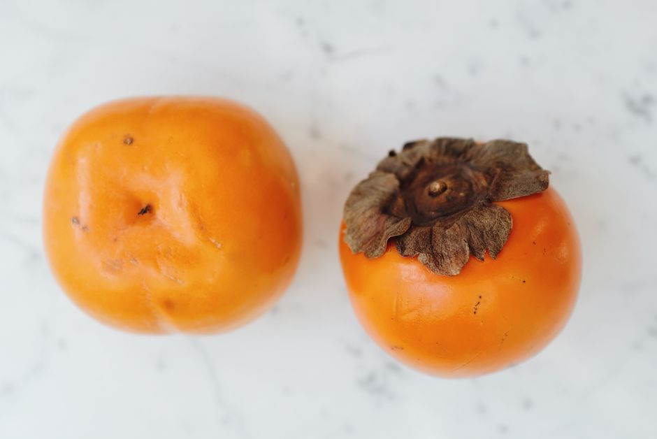 Firm Fuyu persimmon wedges roasted until caramelized at the edges, a simple warm side or dessert topping.