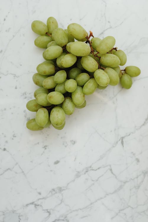 Green Grapes on White Surface