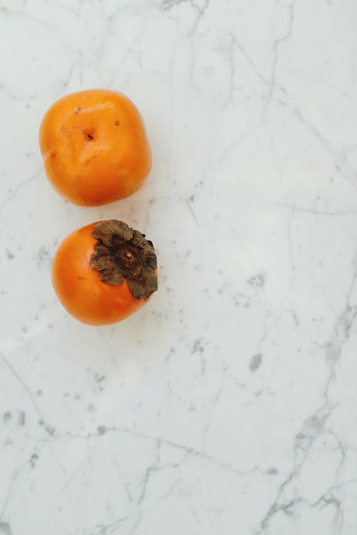 Persimmon on a White Surface