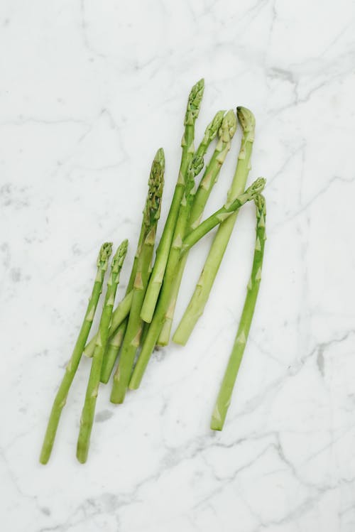 Green Asparagus on White Surface